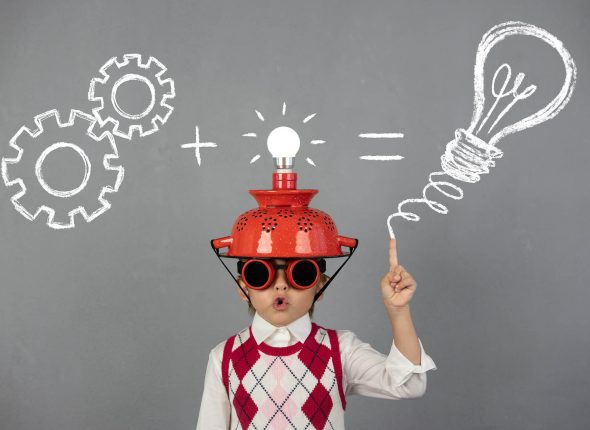 Smart child wearing funny helmet with illuminated lightbulb