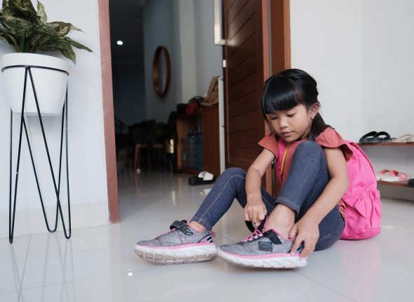primary student preparing to go to school in the morning